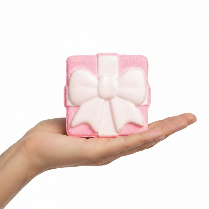 Square, gift-box-shaped Present Bath Fizzer in Sugar Plum with a bow on top.
