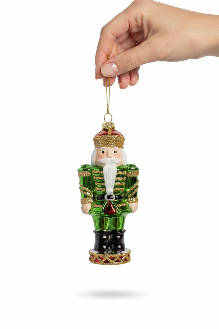 Ashford Nutcracker Ornament in green with a green coat and gold glitter crown and base.