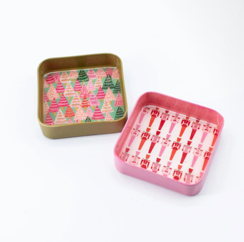 Square Jingle Pop Dice Trays: one metallic gold Christmas tree pattern, one pink nutcracker pattern.