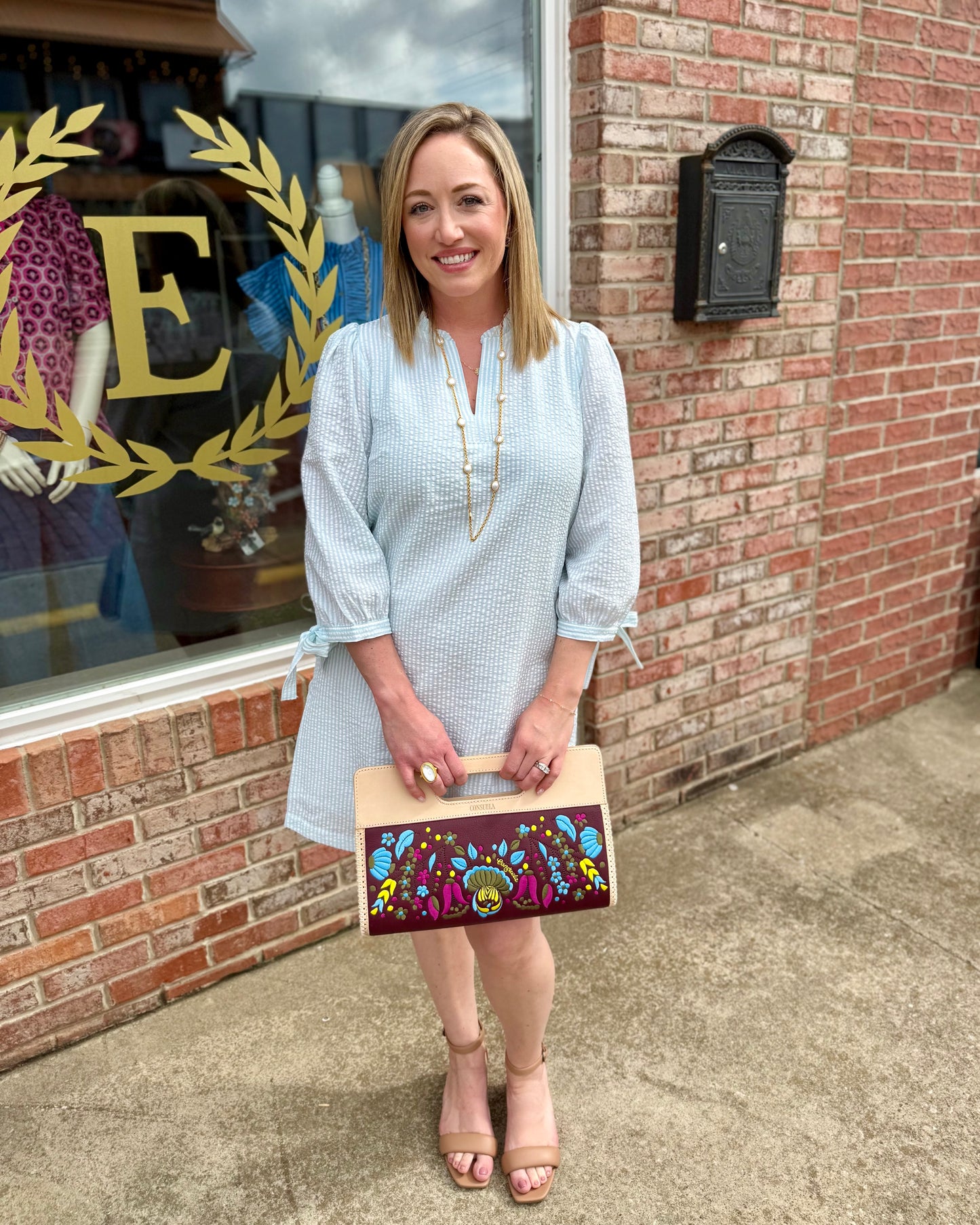 Lainey Seersucker Dress in Seafoam + White, ruffle V-neck, 3/4 sleeves; available in sizes XS–XL.