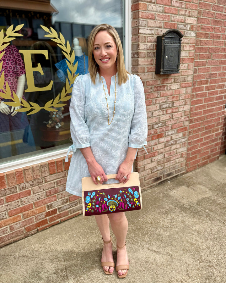 Lainey Seersucker Dress in Seafoam + White, ruffle V-neck, 3/4 sleeves; available in sizes XS–XL.