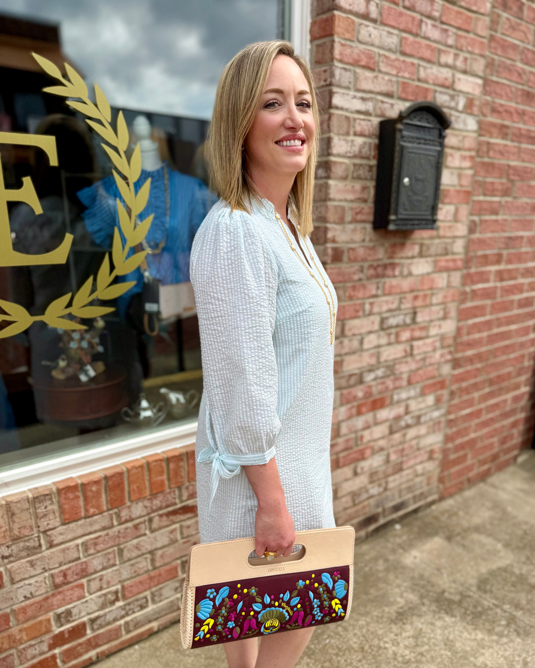 Seafoam and white Lainey Seersucker Dress, available in sizes XS–XL. Features lightweight fabric and subtle textured stripes.