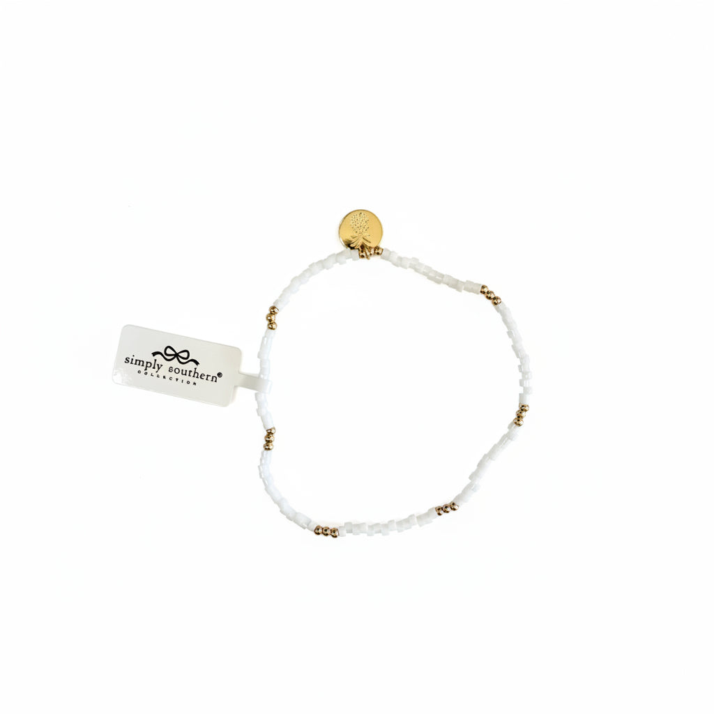 Gold beaded bracelets with white accent beads, gold charm, and "Simply Southern" tag. Available in S/M and M/L sizes.