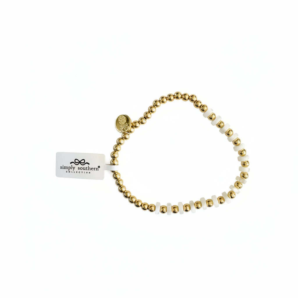 Gold beaded bracelet with white "MAMA" letter beads and round charm. Available in S, M, L.