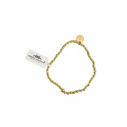 Gold beaded bracelets with green and gold accents, round gold charm, and white “simply southern” tag. Sizes: S, M, L.