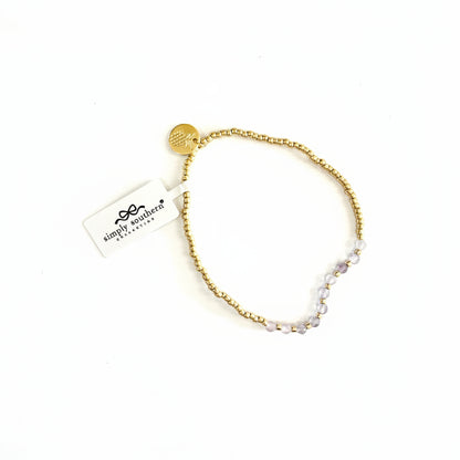 Gold and light purple beaded bracelets with round gold charm, "simply southern" tag; available in S/M and M/L.