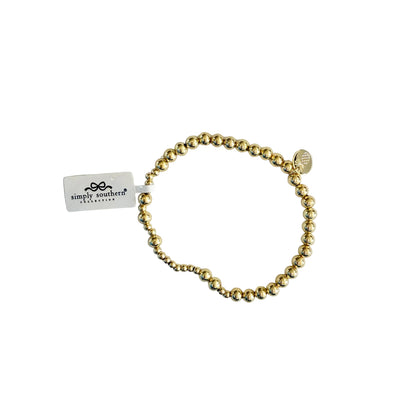 Gold beaded bracelets with accent beads, stretch fit, round charm, and Simply Southern tag. Available in S/M and M/L sizes.