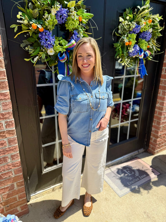Ruffle Detail Button-Up Denim Shirt, available in sizes XS-XL. Features ruffle trim and button front.