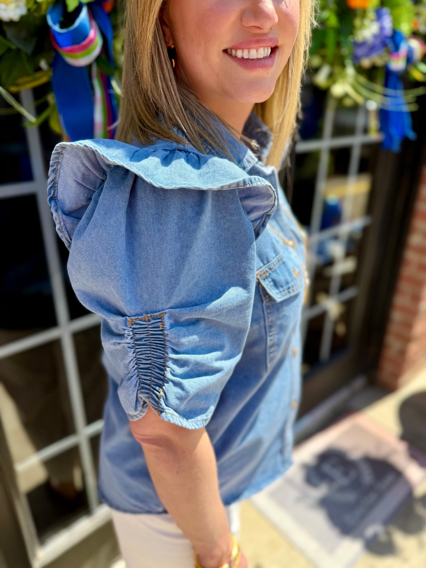 Ruffle Detail Button-Up Denim Shirt with button front and ruffle trim; available in sizes XS to XL.