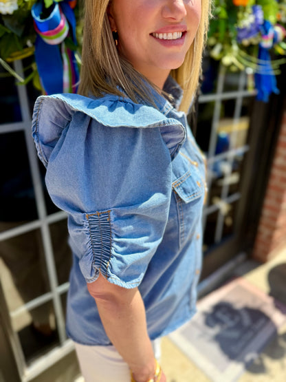 Ruffle Detail Button-Up Denim Shirt with button front and ruffle trim; available in sizes XS to XL.