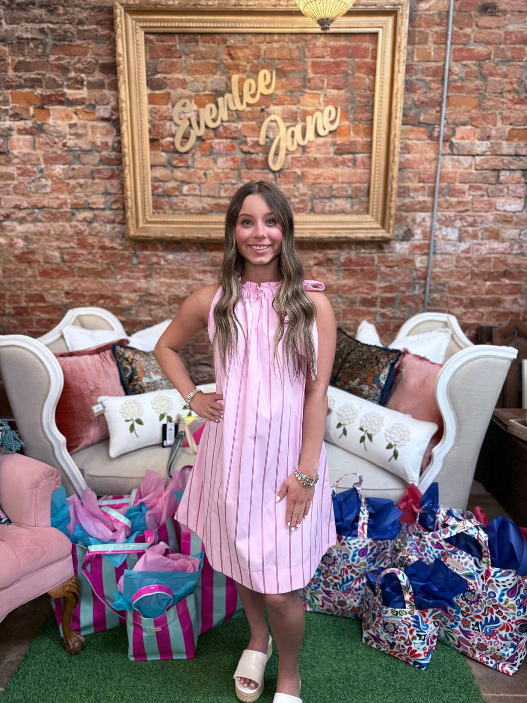 Pinstripe Pink Tie-Neck Sleeveless Dress. Available in sizes XS-XL.