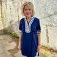 Luxe Woven Accent Dress in navy with white trim. Available in sizes XS–XL.