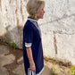 Luxe Woven Accent Dress with white trim, available in sizes XS–XL.
