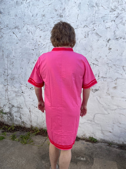 Bright pink Luxe Woven Accent Dress with red trim on sleeves and collar, knee-length. Available in sizes XS–XL.