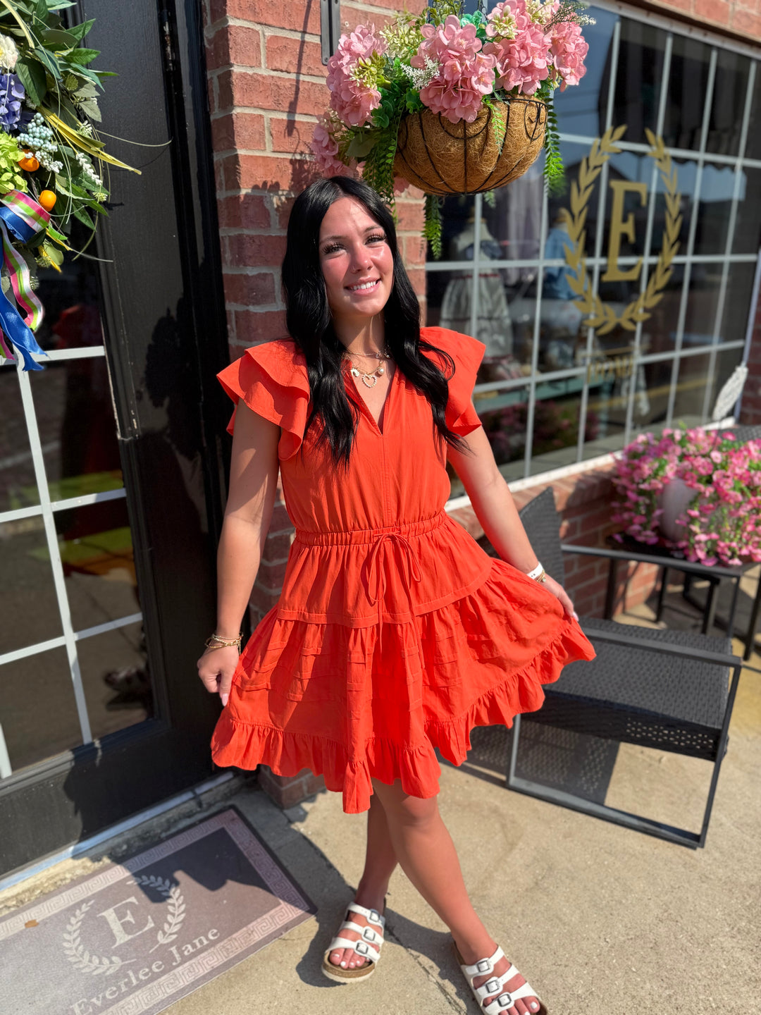 Bright orange Jacket Pride Flutter Sleeve Dress; available in sizes XS–XL.