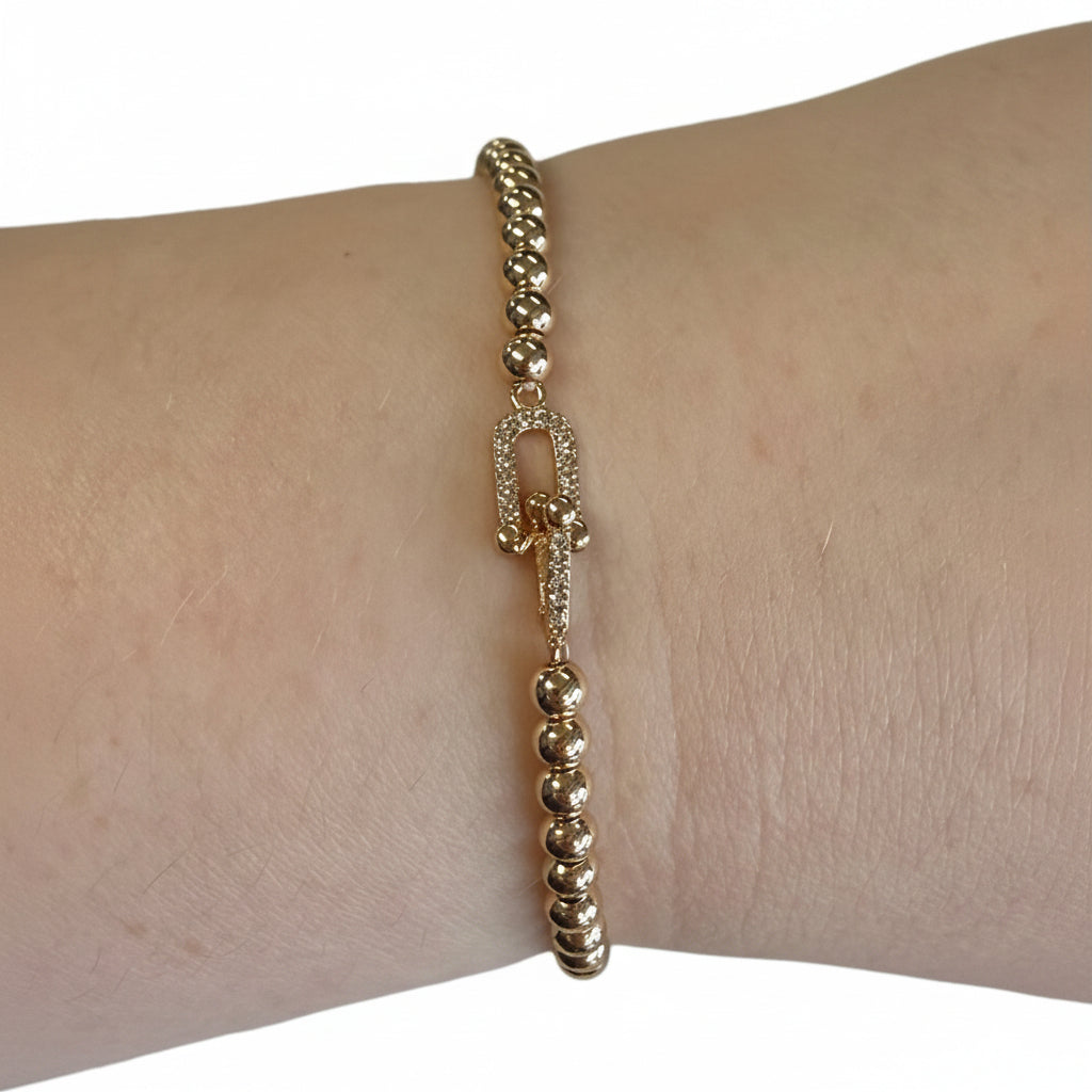 Beaded Gold Stretch Bracelets with oval clasp. Available in small, medium, and large sizes.