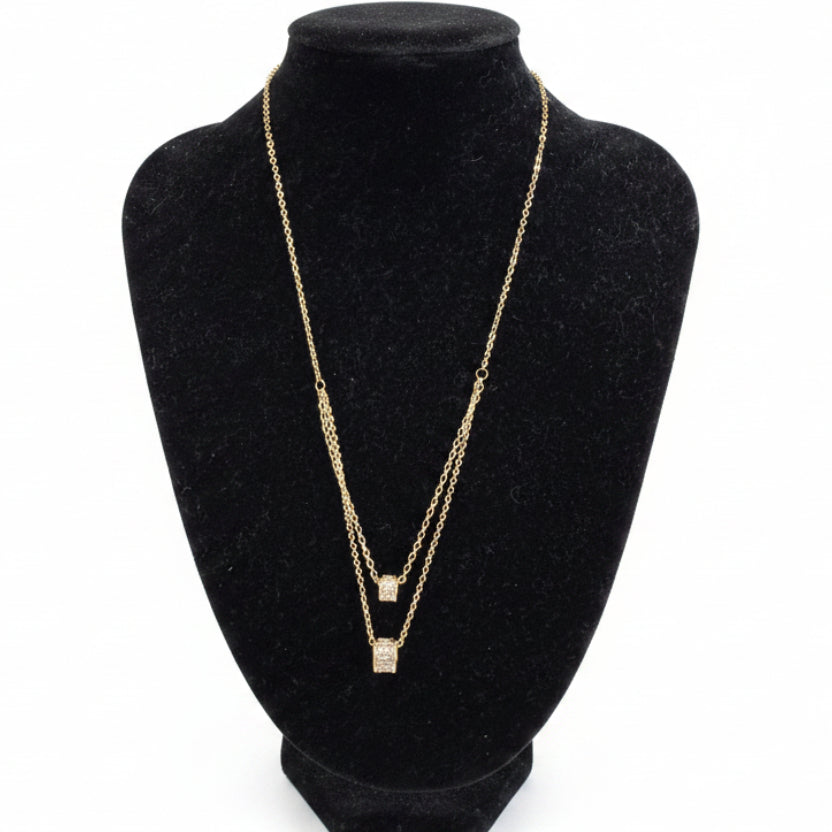 Gold dipped double strand necklace with square cubic zirconia pendants, available in 16" and 18" lengths.