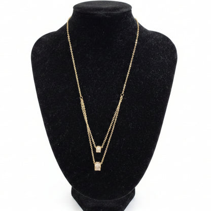 Gold dipped double strand necklace with square cubic zirconia pendants, available in 16" and 18" lengths.