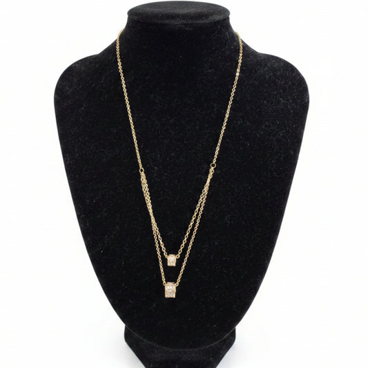 Gold dipped double strand necklace with square cubic zirconia pendants, available in 16" and 18" lengths.