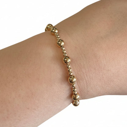 Beaded Gold Dipped Stretch Bracelets with alternating large and small beads. Available in S, M, L sizes.