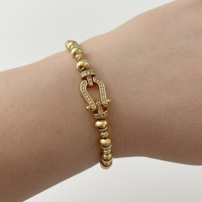 Beaded Gold Dipped Stretch Bracelet with horseshoe-shaped diamond-studded clasp; available in small, medium, and large sizes.