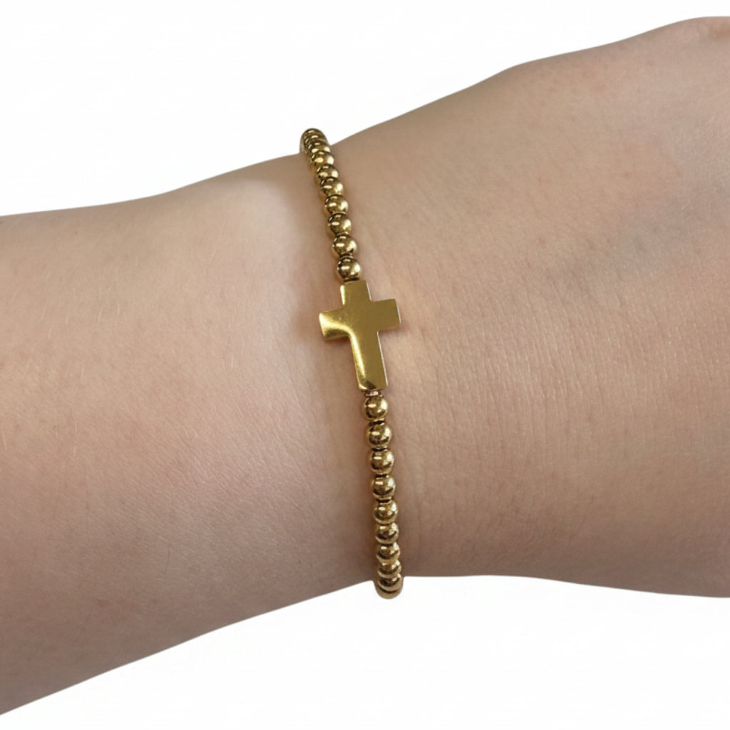 Beaded Gold Dipped Stretch Bracelet with central gold cross charm; available in S, M, and L sizes.
