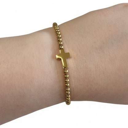 Beaded Gold Dipped Stretch Bracelet with central gold cross charm; available in S, M, and L sizes.