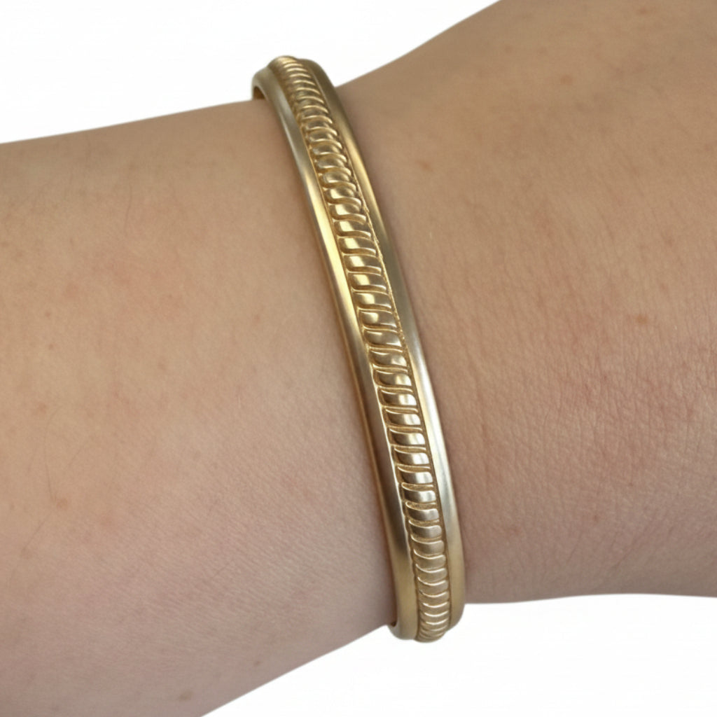 Twisted gold Hinge Bangles with decorative design. Available in small, medium, and large sizes.