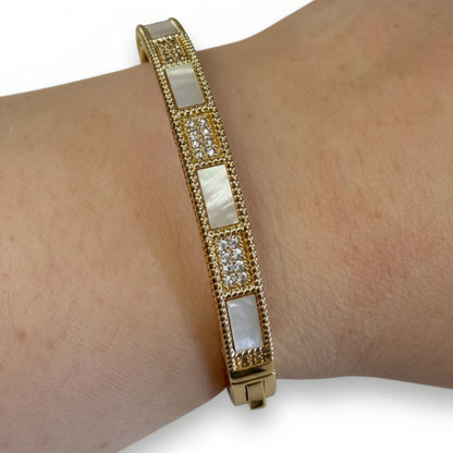 Gold hinged CZ bracelet with mother-of-pearl panels and clear crystals; available in S/M and M/L sizes.