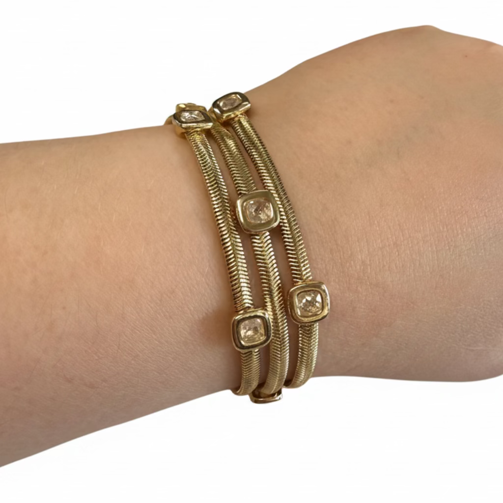 Triple-strand gold Magnetic Dipped Metal Bracelets with rectangular clear CZ stones; available in multiple sizes.