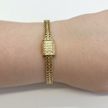 Magnetic Dipped Metal Bracelet with intricate woven gold band and rectangular textured centerpiece. Available in S, M, and L.