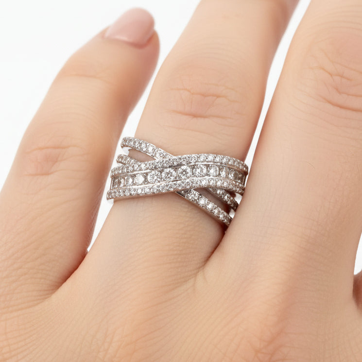 The Ring Edit: multi-band silver statement ring with crisscross diamond-encrusted bands. Available in sizes 5–9.
