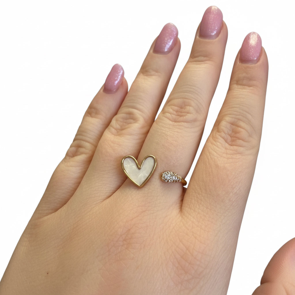 The Ring Edit: gold statement ring with a white heart and clear stones. Available in sizes 6, 7, and 8.