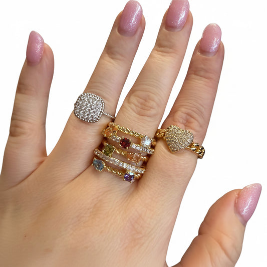 The Ring Edit: gold and silver rings with heart motifs and colorful gems. Available in sizes 5-9.