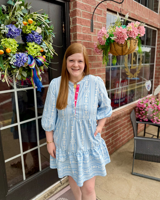 Riley Tulip Tapestry Blue Dress with light blue patterned design, 3/4 sleeves, and tiered skirt. Available in sizes XS-XL.
