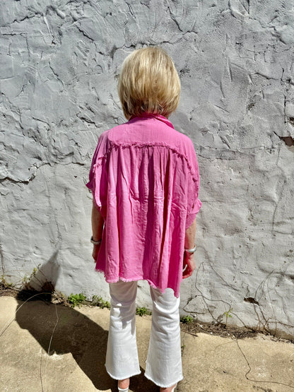 Pink linen button down top with fray details. Available in sizes XS-XL.