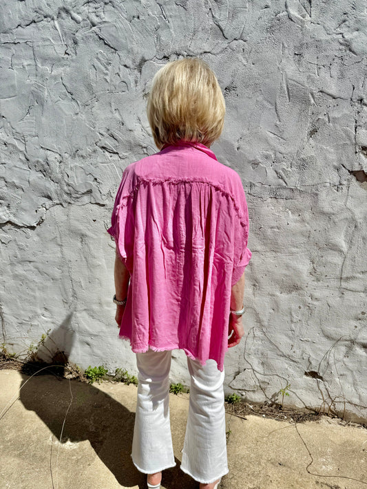 Pink linen button down top with fray details. Available in sizes XS-XL.