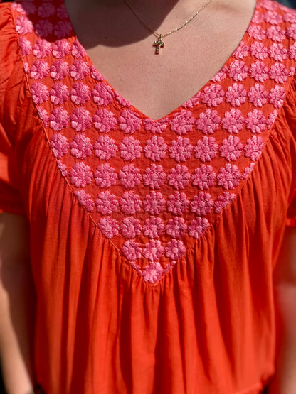 Daisy Filled Yoke Dress: mandarin orange cotton, pink floral V-embroidery. Available in sizes XS-XL.