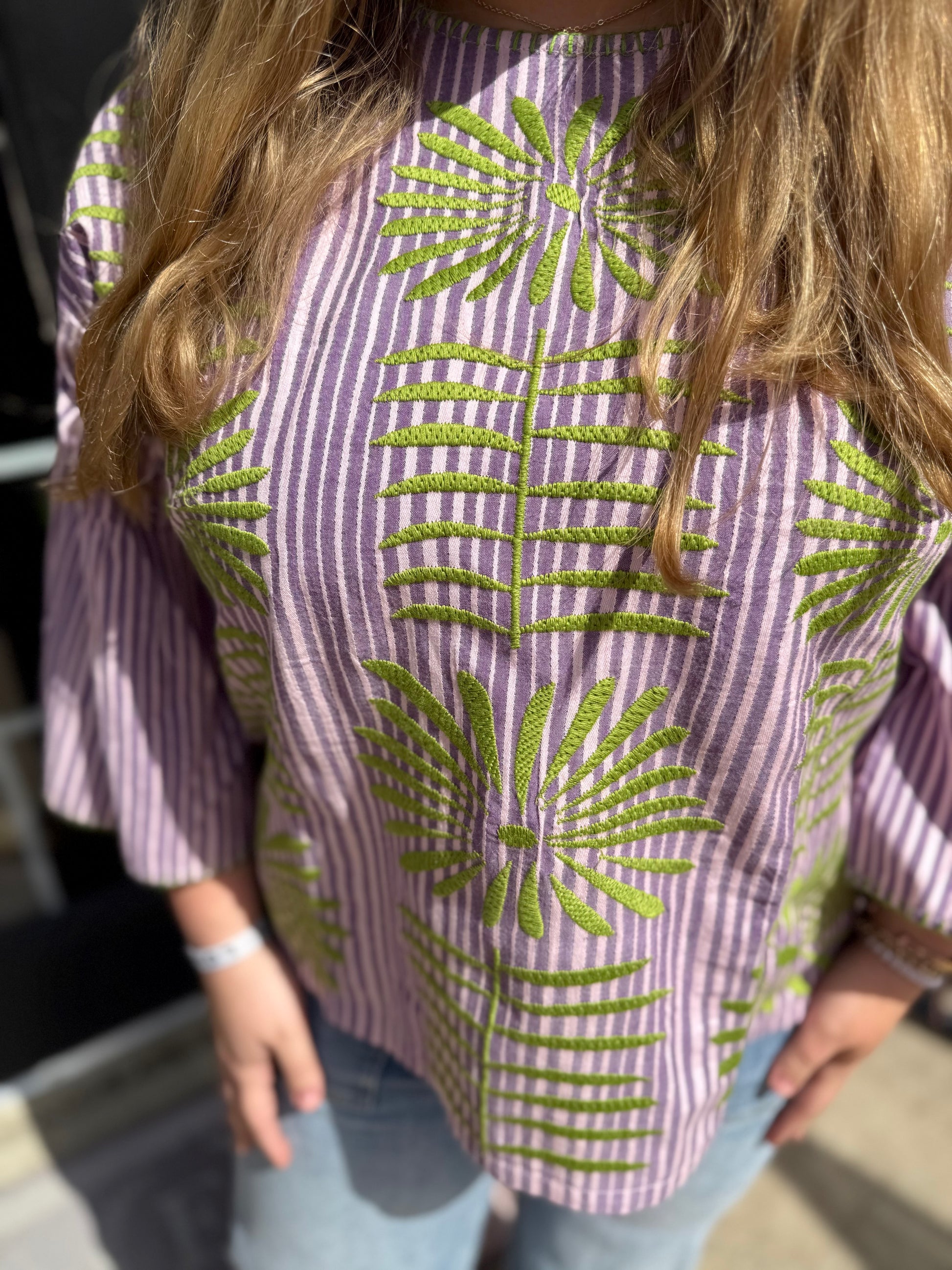 Purple Elena Blouse: striped cotton, green embroidered leaves. Available in sizes XS–XL.