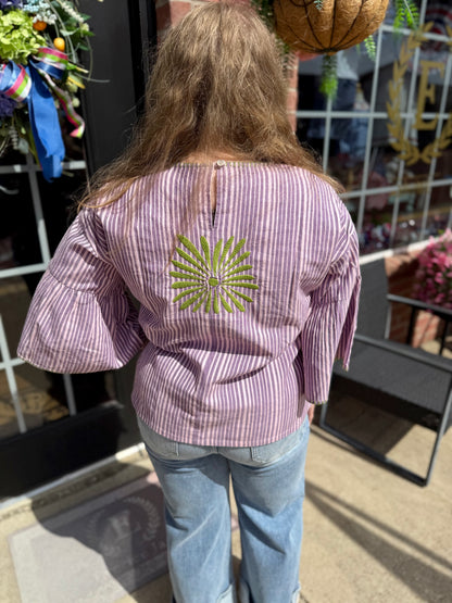 Purple Elena Blouse with wide sleeves and green geometric embroidery on back. Available in sizes XS-XL.