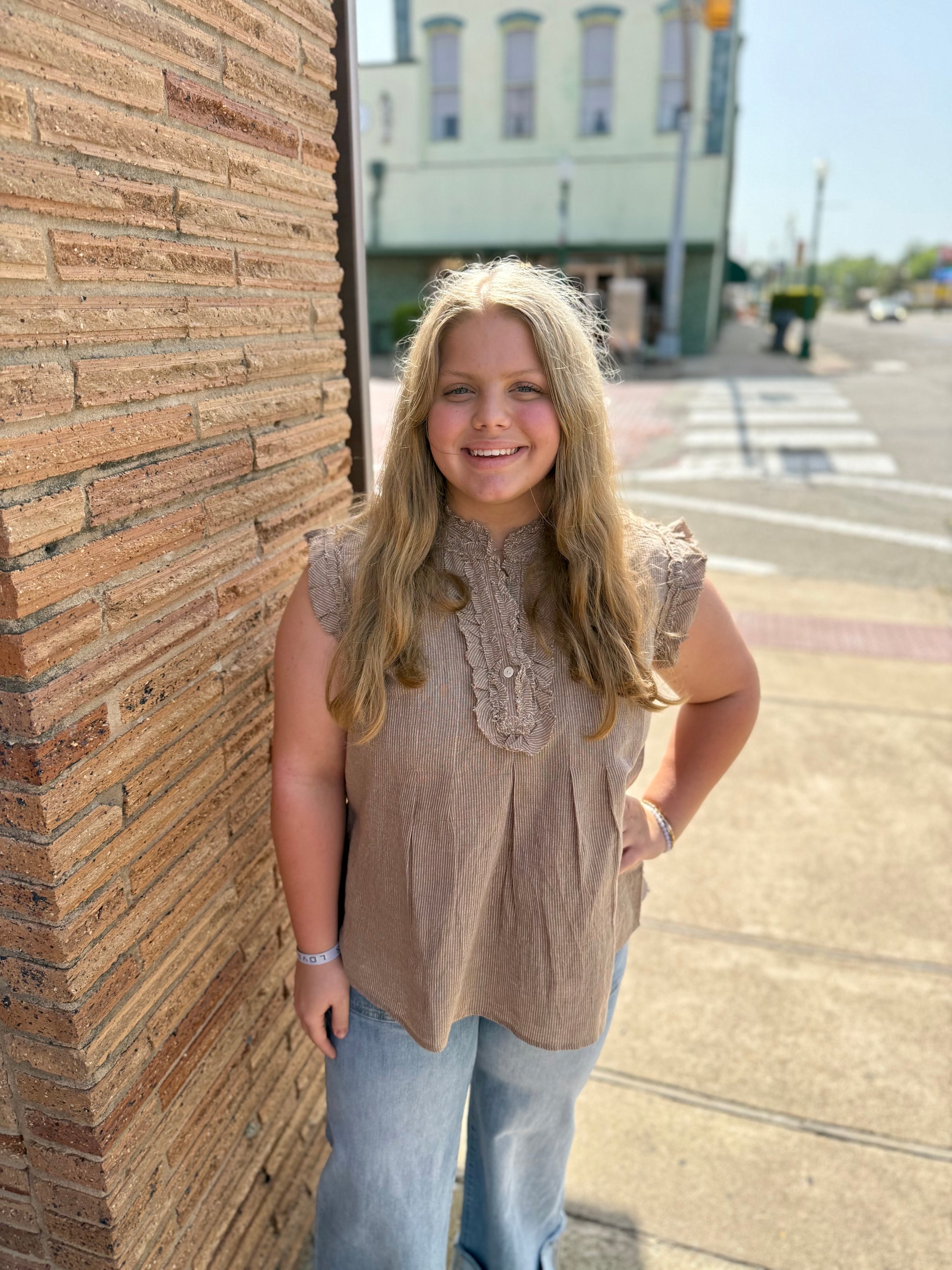 Striped Ruffle Top, available in XS-XL. Features ruffle details and bold stripes. Blue jeans not included.
