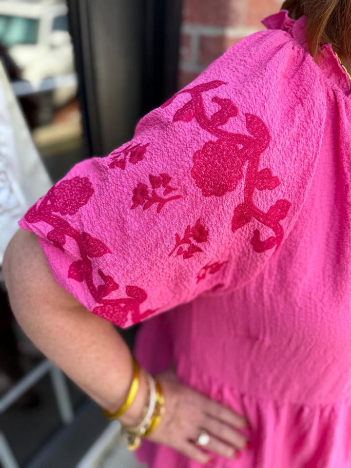 Melissa Peony Embroidered Tiered Dress in bright pink with darker pink floral embroidery on puffy sleeves; babydoll style. Available in sizes XS–XL.