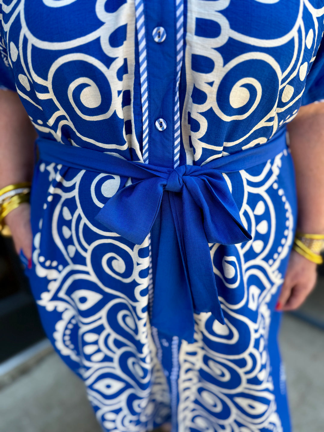 Savannah Paisley Midi Dress with blue and white paisley pattern, adjustable waist tie in a bow. Available in sizes XS-XL.