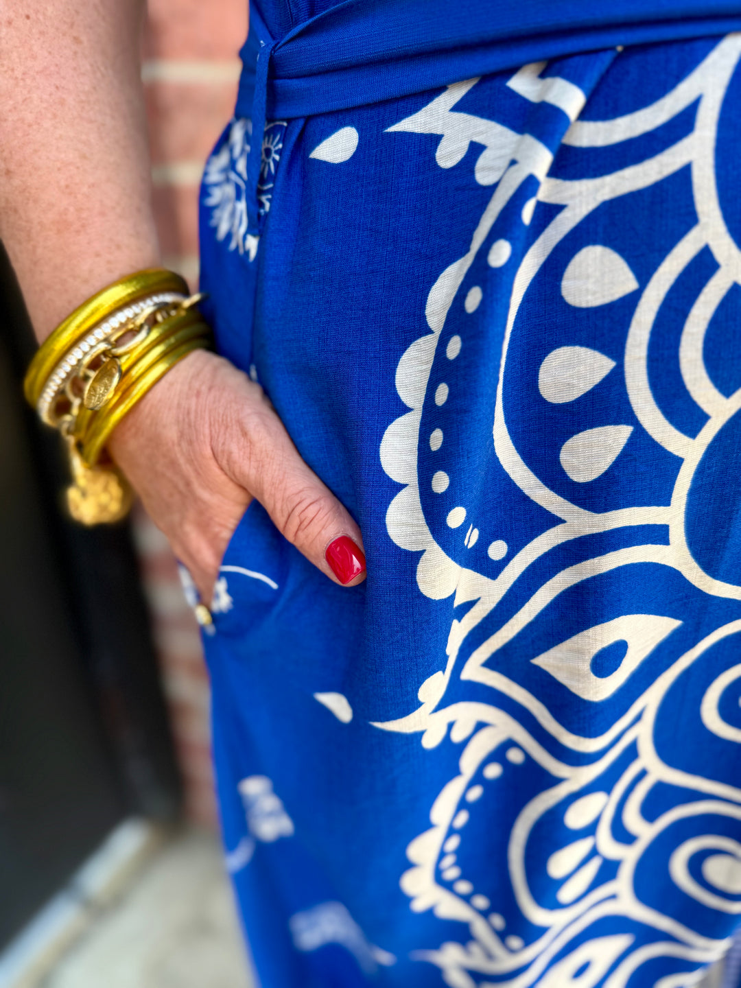 Savannah Paisley Midi Dress in blue and white pattern with adjustable waist tie and pockets; available in sizes XS-XL.