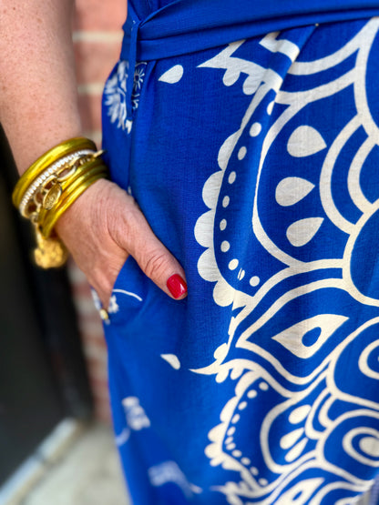 Savannah Paisley Midi Dress in blue and white pattern with adjustable waist tie and pockets; available in sizes XS-XL.