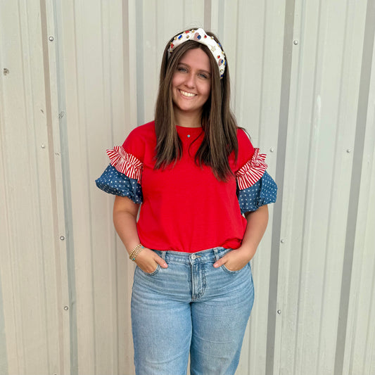 Liberty Ruffle Accent Puff Sleeve Top with blue and red patterns; available in sizes XS-XL.