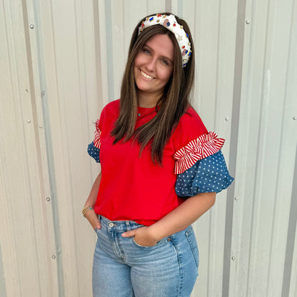 Liberty Ruffle Accent Puff Sleeve Top in red with blue sleeves, available in sizes XS-XL.