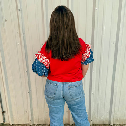 Liberty Ruffle Accent Puff Sleeve Top: red and white striped sleeve, blue polka dot sleeve. Sizes XS–XL.