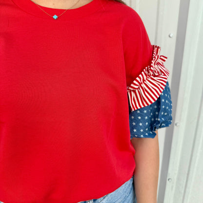 Liberty Ruffle Accent Puff Sleeve Top: red-and-white stripes, blue with white stars. Available in XS-XL.