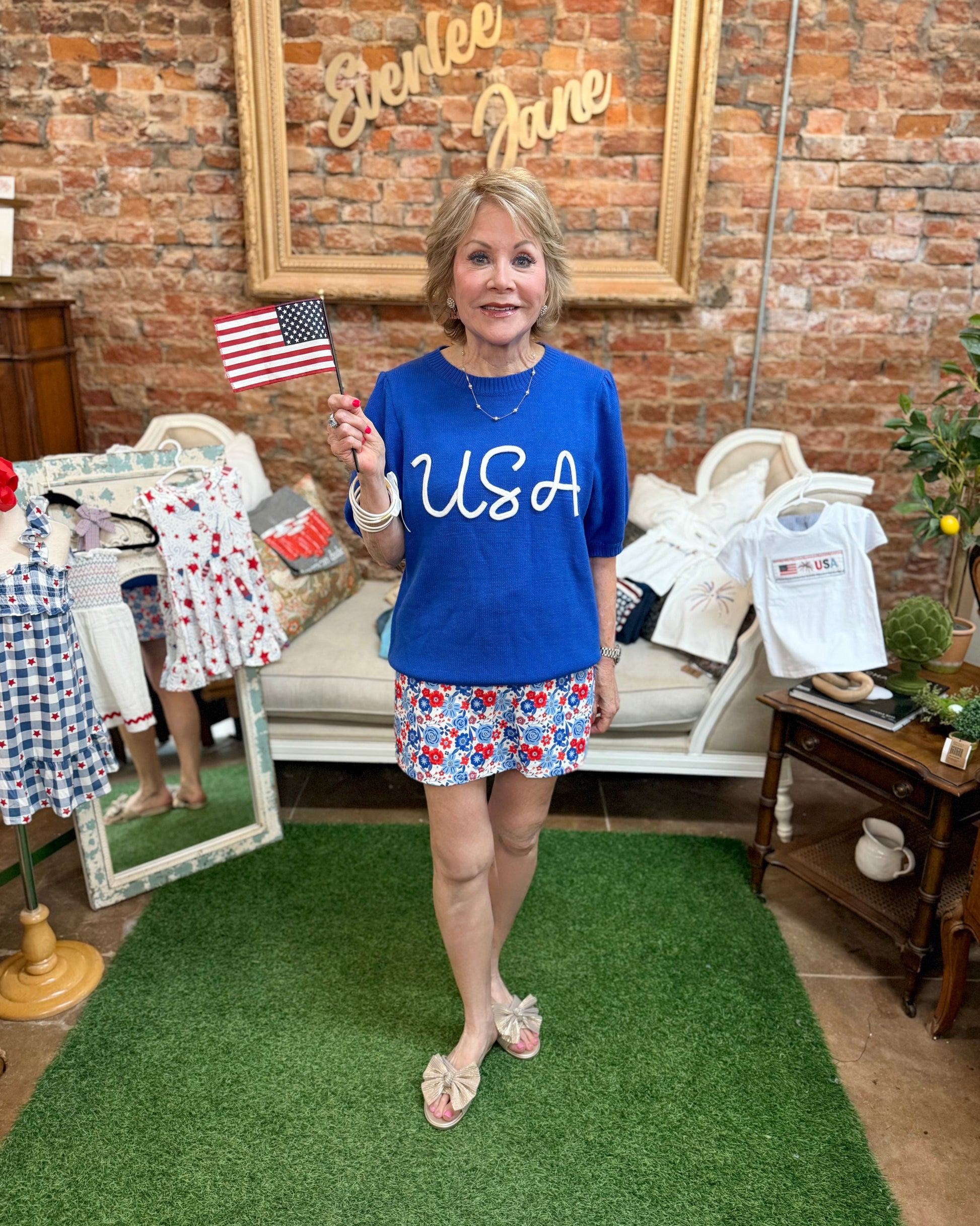 Blue USA Pop Up Letter Sweater Knit Top; available in S-XL. Features bold lettering and a cozy knit texture.
